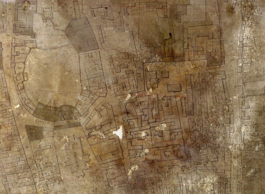 After conservation work. The map is still very dark due to the layer of discoloured varnish which cannot be removed, but it has been flattened and tears and holes filled in. Despite the damage it has suffered, the outlines of the streets and buildings are remarkably clear.