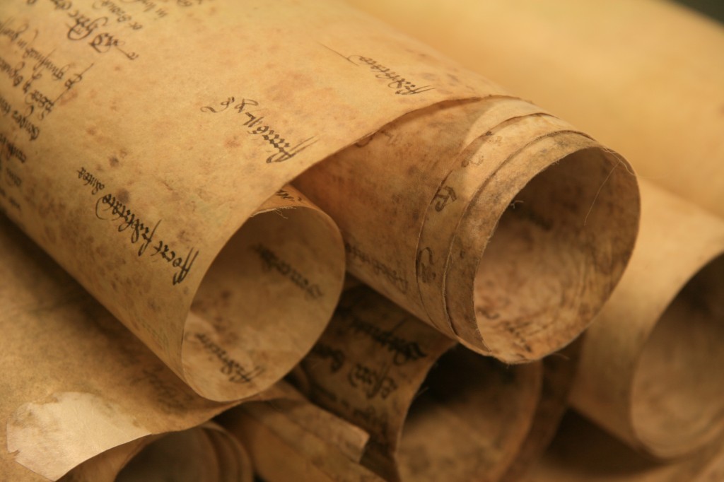 The earliest records are rolls made up of membranes of parchment stitched together at the top.  Although these records are cumbersome and unwieldy to use today, this was the quickest and easiest way to maintain a working accessible record