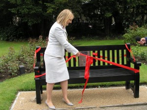 Picture of Cllr Young cutting ribbon on bench