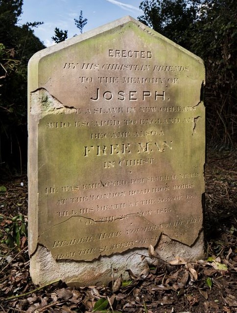 Photograph of the gravestone for Joseph Freeman. The inscription reads: "Erected by his Christian friends, to the memory of Joseph, a slave in New Orleans who escaped to England and became also a Freeman in Christ. He was employed for several years at the London Road Iron Works till his death at the age of 45 on the 28th Nov 1875. Reader! Have you been made free from the slavery of sin."