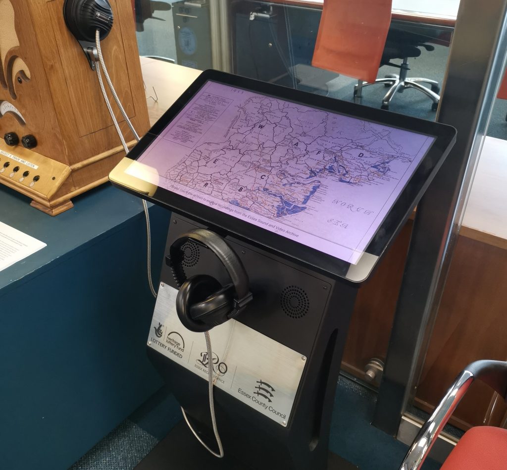 Listening post with headphones and touchscreen. On the touchscreen is a map of the areas affected by the flood.