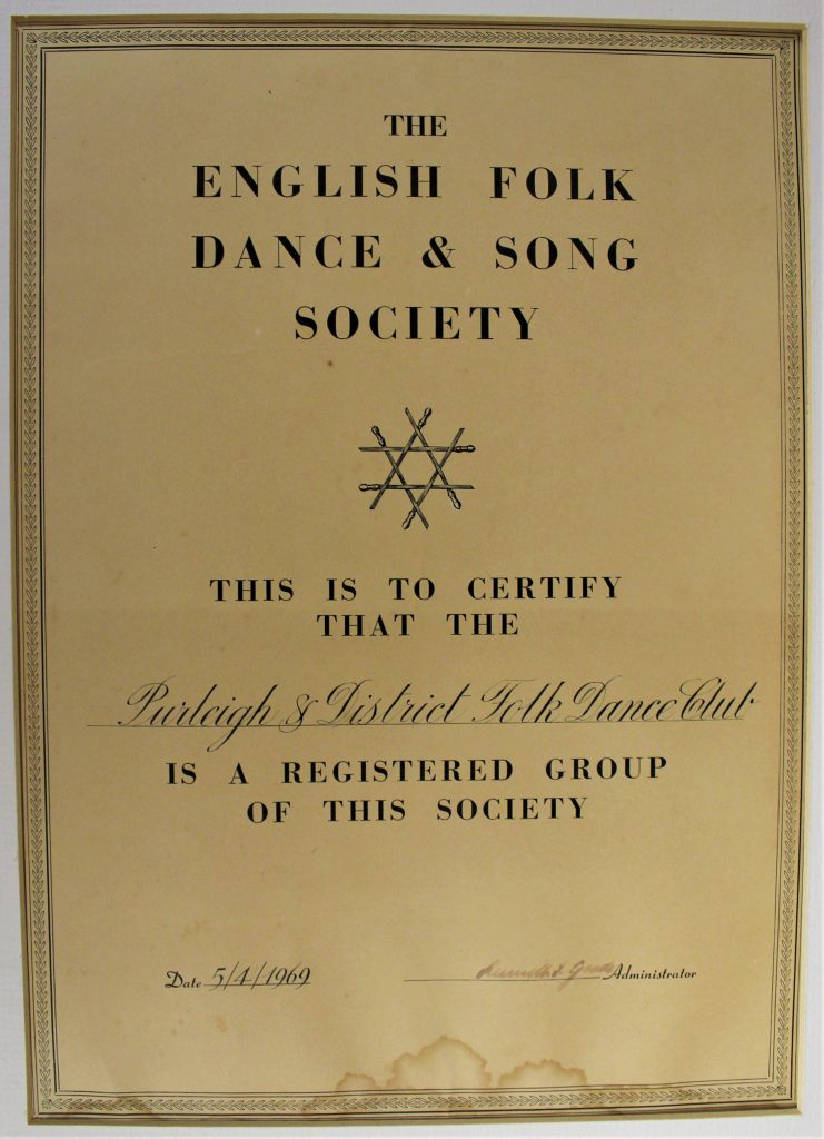 Certificate given by the English Folk Dance and Song Society to Purleigh and District Folk Dance Club in 1969. The certificate is cream, with a bordered edge and the logo of the EFDSS, six interlocked swords.