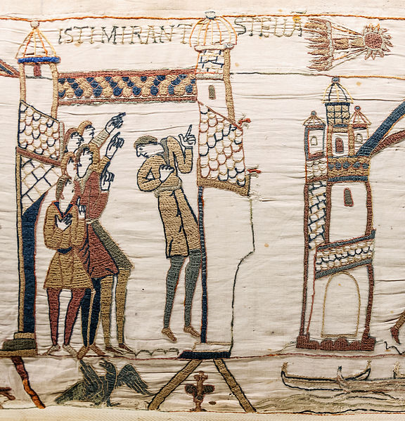 Section of the Bayeux Tapestry showing the comet in the sky with a group of six men looking and pointing towards it
