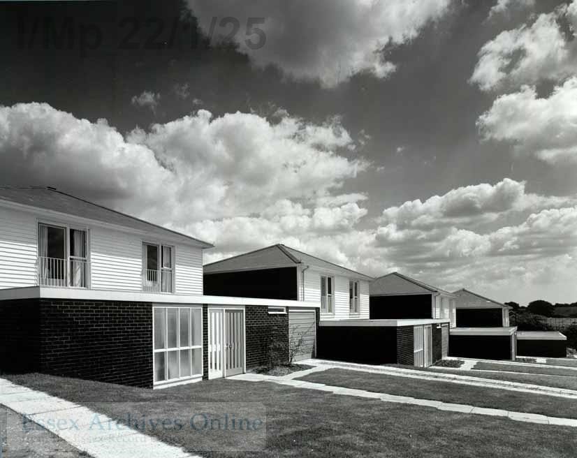 Black and white photograph of two storey houses with garages
